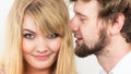 Man whispering to woman ear sharing secret. Royalty Free Stock Photo