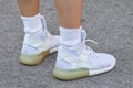 Man with white Adidas tubular shoes before Diesel Black Gold fashion show, Milan Fashion Week street style on