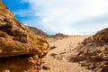 Man in white arab clothing walks in a colored canyon in Egypt Dahab South Sinai