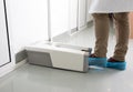 Doctor putting protective shoes on in laboratory