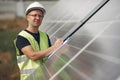 Man in a white helmet near a solar panel Royalty Free Stock Photo