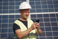 Man in a white helmet near a solar panel Royalty Free Stock Photo