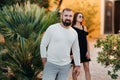 A man in a white jacket and a young girl in a black dress are standing near green bushes.A man and a girl in Italy Royalty Free Stock Photo