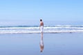 A man in white pants and with naked torso standing against the against ocean Royalty Free Stock Photo
