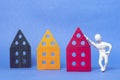 A man in white plasticine is standing leaning on a toy house. Royalty Free Stock Photo
