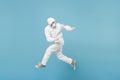 Man in white protective suit respirator mask run jump isolated on blue background studio. Epidemic pandemic new rapidly Royalty Free Stock Photo