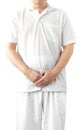 A man in a white robe meditating against a white background with a clipping path