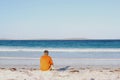 Man at beach looks out over the ocean, Bremer Bay, Western Australia