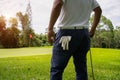 man white shirt blue pants In the hand holding a golf ball, prepare to play the next golf shot Royalty Free Stock Photo