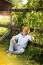 Man sits by fence near sunflowers Royalty Free Stock Photo