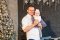 Man in white shirt and daughter in Christmas dress