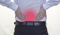 A man in a white shirt holds on to the back, back pain, red back, white background businessman Royalty Free Stock Photo