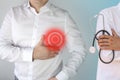 Man in a white shirt holds on to his chest in the heart area, a red circle, a symbol of throbbing pain, a doctor is standing next