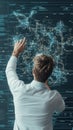 Man in white shirt interacting with glowing digital network grid with data streams, symbolizing fintech advancements and Royalty Free Stock Photo