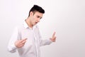 Man in white shirt looking down. Pointing, explaining, gesturing. Royalty Free Stock Photo