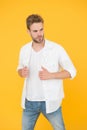 Man in white shirt. Muscular man in jeans yellow background. fashion and people concept. Sexy and handsome. Confident Royalty Free Stock Photo