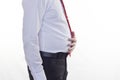 A man in a white shirt and red tie, a big belly holding his stomach, a white background stomach Royalty Free Stock Photo