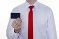 A man in a white shirt and red tie is holding a clean credit card for the inscription, white background