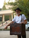 Man in a white t-shirt and a black hat with a barrel organ in Tsvetnik Park in Pyatigorsk, Russia Royalty Free Stock Photo