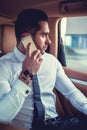 A man in a white t shirt talking by smartphone. Royalty Free Stock Photo