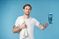 man in white t-shirt tattoos on his arms water bottle fitness lifestyle