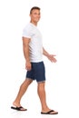 Man In White T-shirt Is Walking And Looking At Camera. Royalty Free Stock Photo