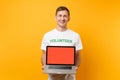 Man in white t-shirt written inscription green title volunteer hold laptop pc computer with blank empty screen isolated Royalty Free Stock Photo