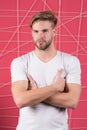 Man in white tshirt with folded hands. Guy with bearded unshaven face. Macho with blond hair, stylish haircut. Hair care in salon Royalty Free Stock Photo