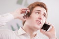 Man in white with two mobile phones Royalty Free Stock Photo