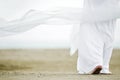 Man in white walking on sand Royalty Free Stock Photo