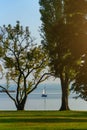 Man on the white yacht on the lake feeding swans.Italy. Royalty Free Stock Photo