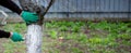 a man whitewashes trees in the garden in spring. Selective focus Royalty Free Stock Photo