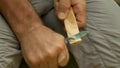 A man whittling a piece of wood