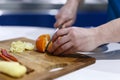 Man who cuts citrus on a wooden hoe Royalty Free Stock Photo