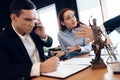 Man who divorces his wife consults on phone with lawyer. Disconcerted woman sits next to man talking on phone.