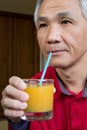 Man who drinking Orange juice Royalty Free Stock Photo