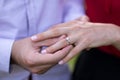 Man who just proposed to his girlfriend putting the ring on her finger Royalty Free Stock Photo
