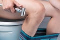 Man who sits in the toilet before washing, after emptying the bowels, close-up