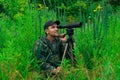 Male explorer makes observations in the wild with a spotting scope Royalty Free Stock Photo