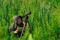 Man wildlife researcher makes field observation with a spotting scope Royalty Free Stock Photo