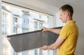 Man with window blind. Royalty Free Stock Photo