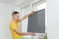 Man with window blind. Royalty Free Stock Photo