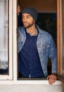 Man, window and winter fashion or thinking, house or hipster with serious male person standing in warm clothes. Beanie