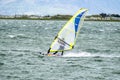 Man windsurfing close to the town of Caernarfon in Wales - United Kingdom