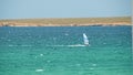 Man Windsurfing in the water during a sunny summer day. Shot. Beautiful view of the sea and windsurfer on a Sunny day