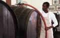 Man winegrower working in wine cellar