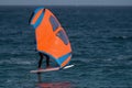 A man is wing foiling using handheld inflatable wings and hydrofoil surfboards Royalty Free Stock Photo