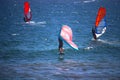 Man wing foiling among windsurfers at the Atlantic ocean