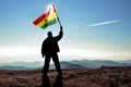 Man winner waving Bolivia flag on top of the mountain peak Royalty Free Stock Photo