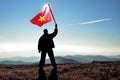 Man winner waving Vietnam flag on top of the mountain peak